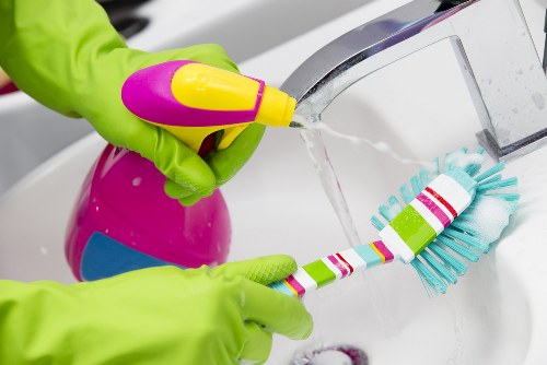 Cleaning supplies used for oven cleaning on a kitchen counter